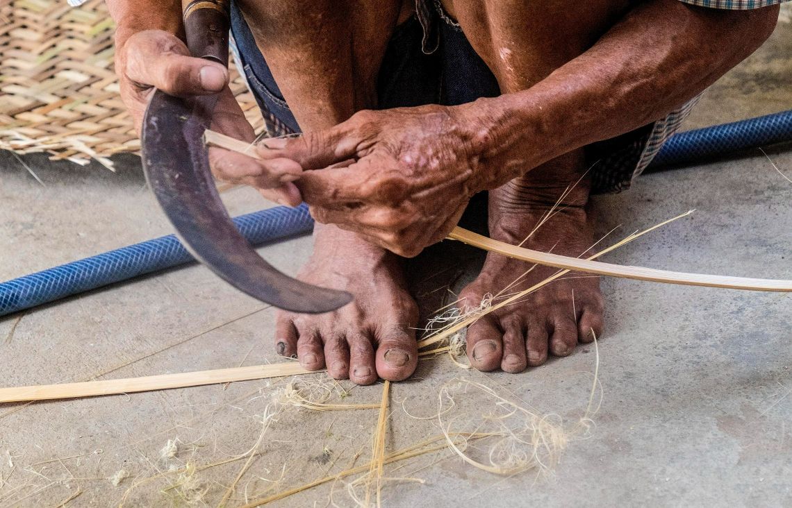 Hand of a Man Weaving a Basket